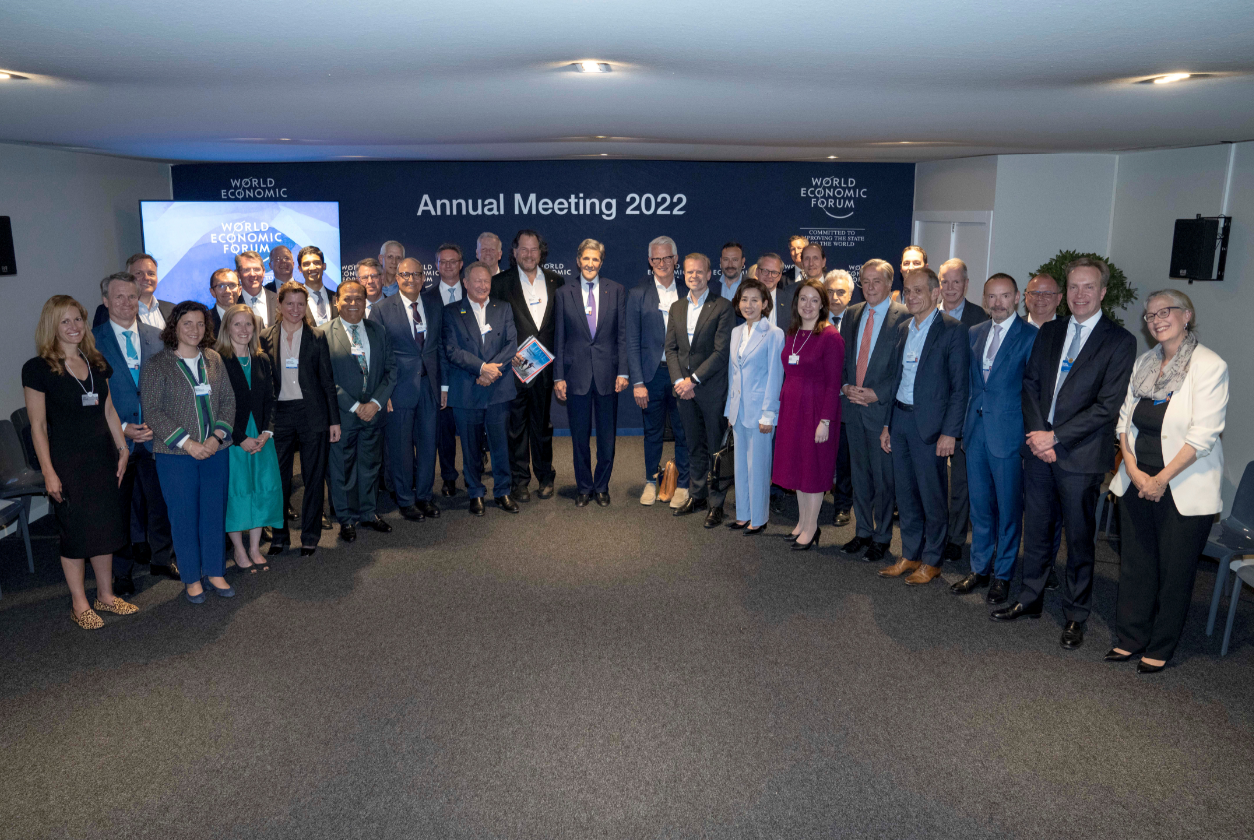 Large group of formally dressed attendees posing together at the World Economic Forum Annual Meeting 2022.